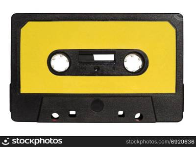 magnetic tape cassette isolated over white. black magnetic tape cassette for analog audio music recording with yellow label isolated over white background