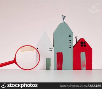magnifier and wooden house on a brown background. Real estate rental, purchase and sale concept. Realtor services, building repair and maintenance