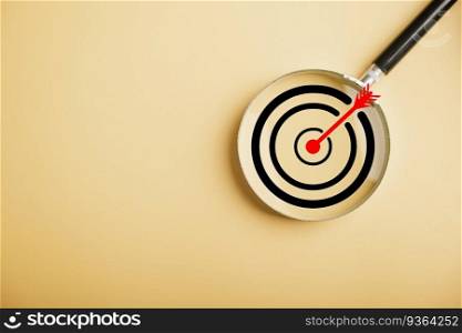 Magnifier glass highlights a target board, showcasing the precision in business objective focus. background and copy space, it conveys the significance of marketing strategies and corporate growth.