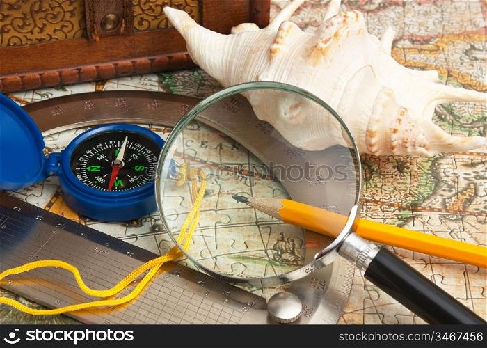 magnifying glass and a compass on the old map