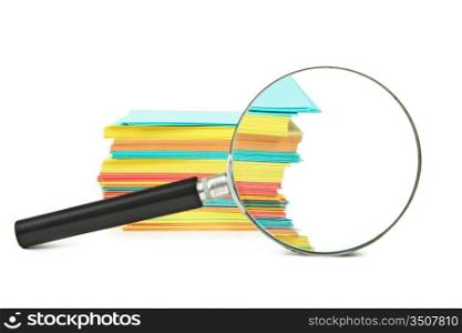 magnifying glass and a stack of paper for notes