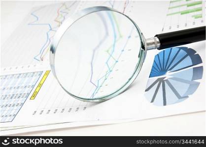 magnifying glass and the working paper with a diagram