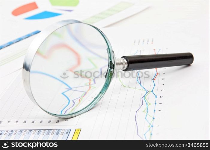 magnifying glass and working paper chart