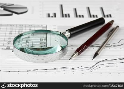 magnifying glass and working paper with diagram