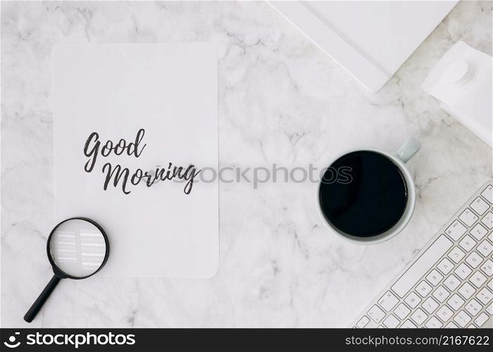 magnifying glass good morning paper with coffee cup diary keyboard white marble desk