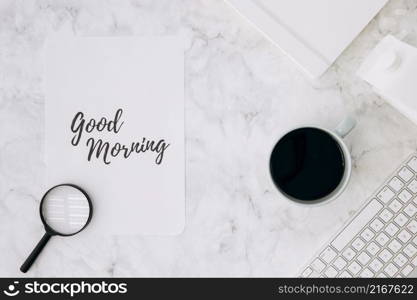 magnifying glass good morning paper with coffee cup diary keyboard white marble desk