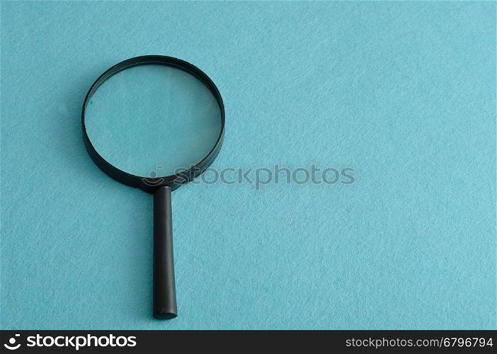 Magnifying glass isolated on a blue background