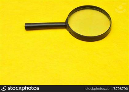 Magnifying glass isolated on a yellow background