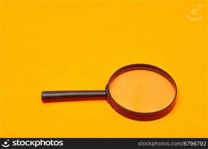 Magnifying glass isolated on an orange background