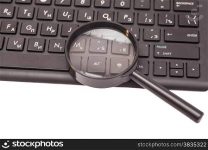 Magnifying Glass on black keyboard