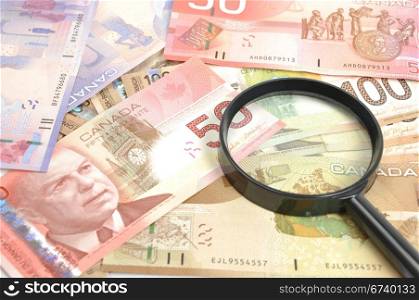Magnifying glass on Canadian money