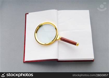 Magnifying glass over the stack of books