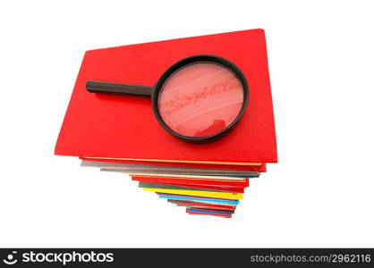 Magnifying glass over the stack of books