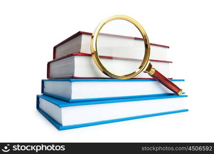 Magnifying glass over the stack of books