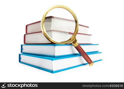 Magnifying glass over the stack of books