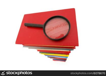Magnifying glass over the stack of books&#xA;