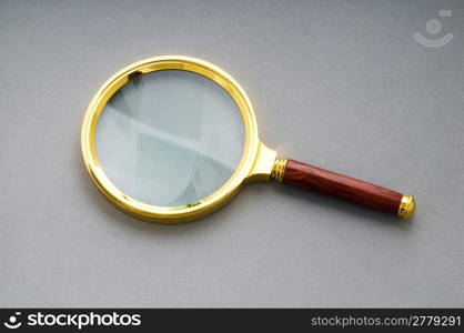 Magnifying glass with wooden handle on the flat surface