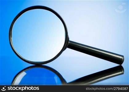Magnifying glass with wooden handle on the flat surface