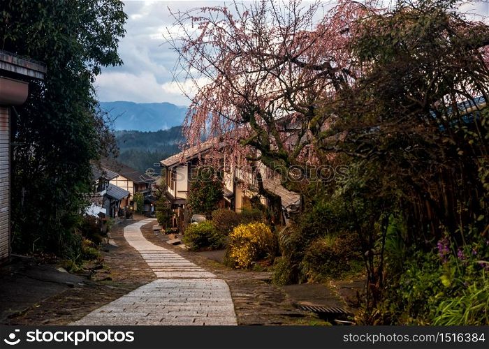 Magome juku old town with sakura or cherry blossom in spring, Kiso valley district, Nagano. Wooden buildings along downhill path. Famous travel destination in Chubu, Japan.