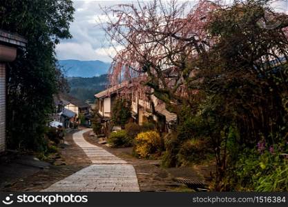 Magome juku old town with sakura or cherry blossom in spring, Kiso valley district, Nagano. Wooden buildings along downhill path. Famous travel destination in Chubu, Japan.
