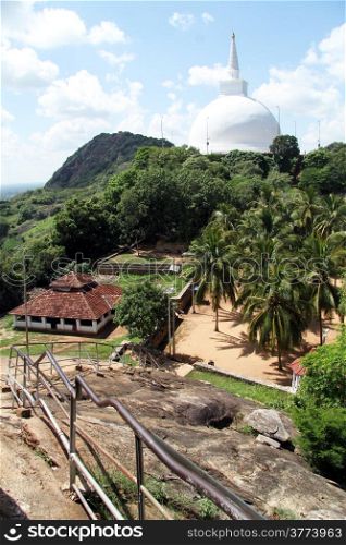 Maha Stupa and building with tile roof in Mihintale, Sri Lanka