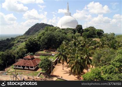 Maha stupa and building with tile roof in Mihintale, Sri Lanka