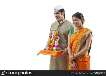 Maharashtrian couple with a Ganesh idol