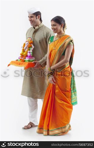 Maharashtrian couple with a Ganesh idol
