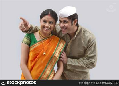 Maharashtrian man pointing something out to woman