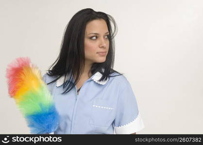 Maid holding feather duster