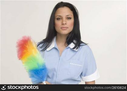 Maid holding feather duster
