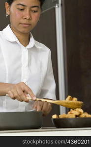 Maid preparing food in the kitchen