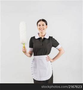 maid with duster smiling
