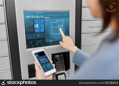 mail delivery, technology and post service concept - close up of woman with smartphone choosing operation on outdoor automated parcel machine&rsquo;s touch screen. woman with smartphone at automated parcel machine