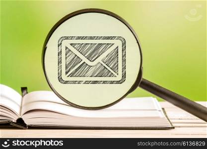 Mail search with a pencil drawing of a letter in a magnifying glass