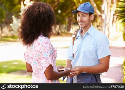 Mailman Delivering Letters To Woman