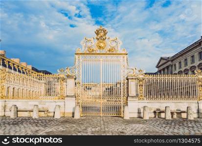 Main golden door in exterior facade of Versailles Palace, Paris, France