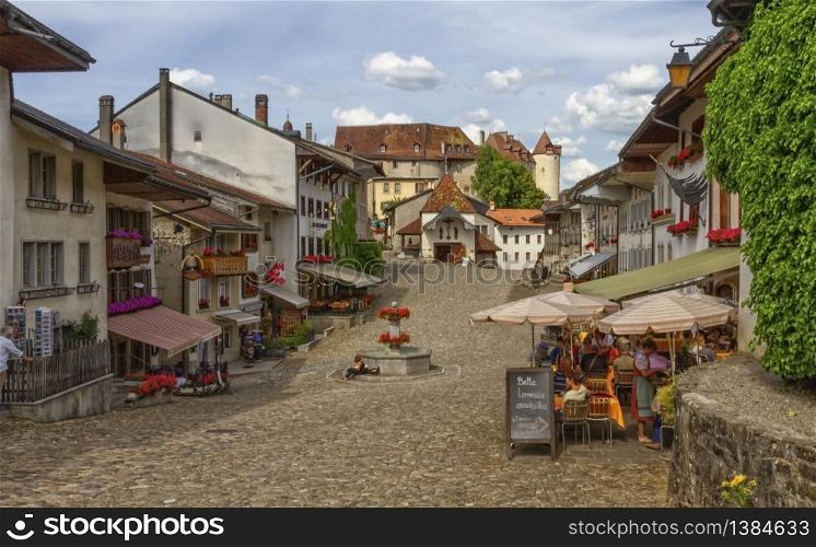 Main street in Gruyere village in Fribourg canton by beautiful day, Switzerland. Gruyere village in Fribourg canton, Switzerland