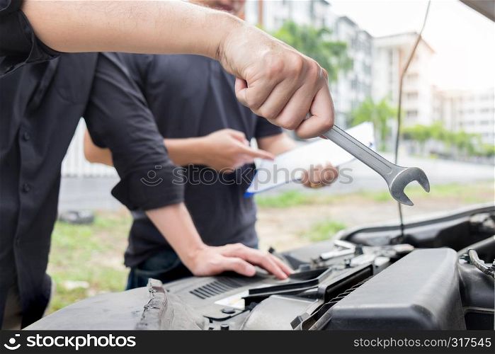 Maintenance car repair automotive concept, Man checking car mechanic working under car hood in garage.