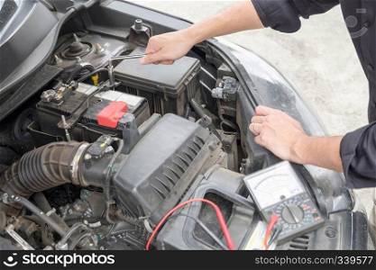 Maintenance car repair automotive concept, Man checking car mechanic working  under car hood in garage.