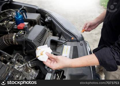 Maintenance car repair automotive concept, Man checking car mechanic working under car hood in garage.