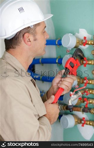 maintenance engineer checking technical data of heating system