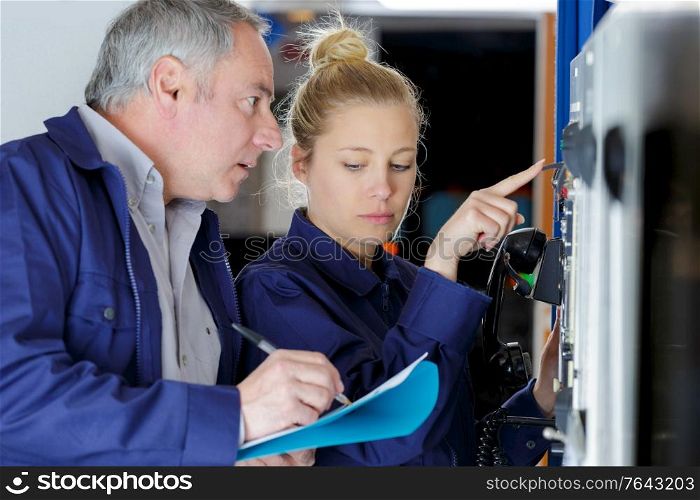 maintenance engineer operating a control panel