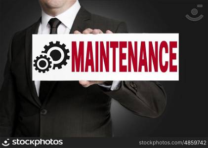maintenance only sign is held by businessman. maintenance only sign is held by businessman.