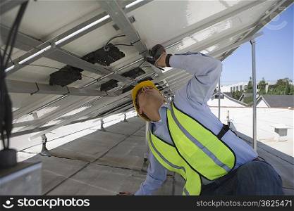 Maintenance worker adjusting solar panel in Los Angeles California