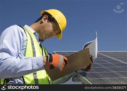 Maintenance worker with photovoltaic array in Los Angeles California