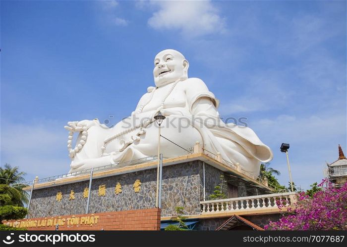 Maitreya Buddha statue located in the famous Vinh Trang pagoda in My Tho city, Tien Giang province, Vietnam.