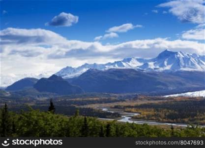 Majestic Chugach Mountain Range and graceful bends of the Matanuska River as seen from Glenn Highway in Alaska.