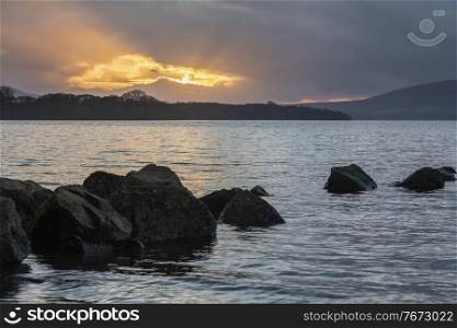 Majestic landscape image of Milarrochy Bay on Loch Lomond in Scottish Highlands with stunning Winter evening ligh