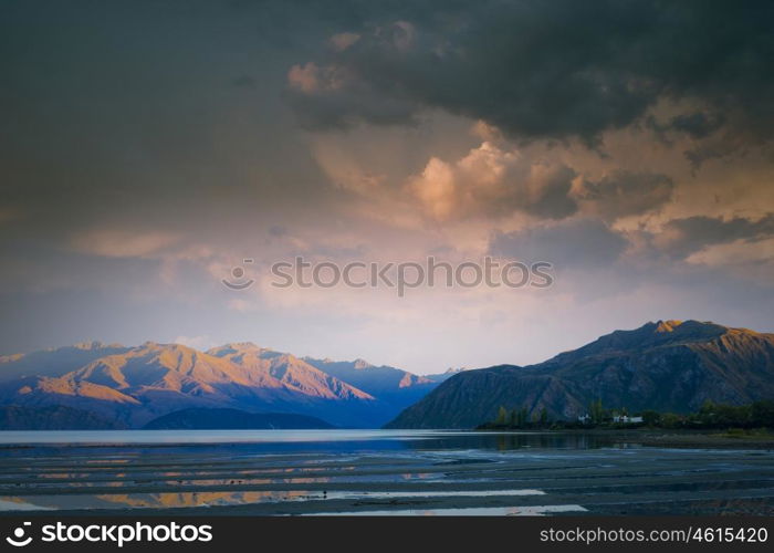 Majestic mountain lake. Beautiful natural landscape of mountain lake and field